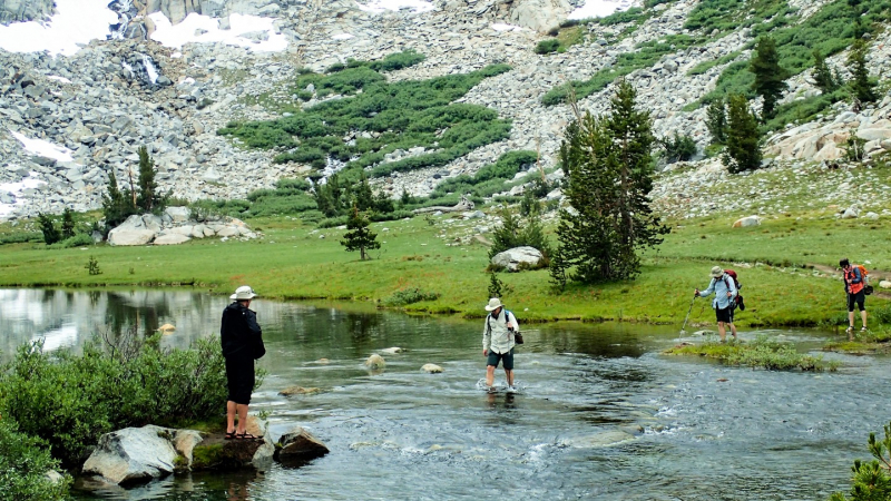 Participants in a Yosemite Conservancy Outdoor Adventure to Mount Lyell cross the Lyell Fork of the Tuolumne River, which is fed by meltwater from the Lyell and Maclure glaciers. What will happen to this tributary and the river downstream as the ice disappears? With support from donors, scientists are investigating that question. Photo: Roy Williams Photography