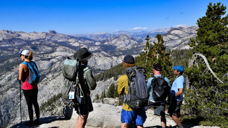 Yosemite Conservancy naturalist guides Pete and Sean take in Sierra views during a 2018 Outdoor Adventure to Clouds Rest and Half Dome. Photo: Fred Turner